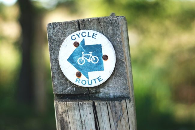 gemma-evans-LTEo69JUv7o-unsplash-1-scaled-e1676982784896 Cycle route sign
