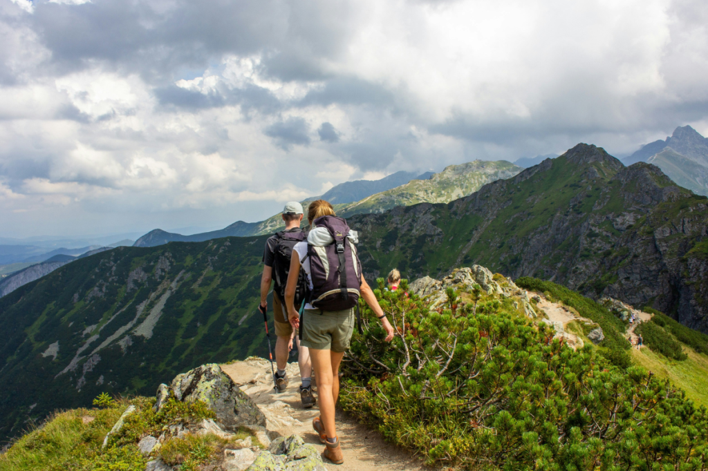 A couple hike over a mountain ridge