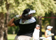 Woman wearing a visor hitting a tee shot